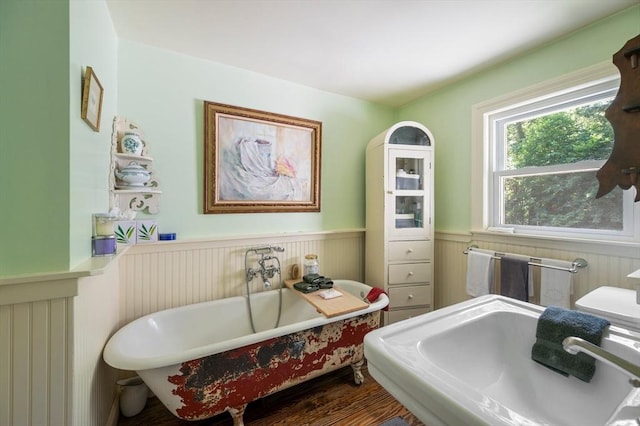 63 Hawthorne, Weymouth, MA 02189 - bathroom with a wainscoted wall, a freestanding bath, a sink, and wood finished floors