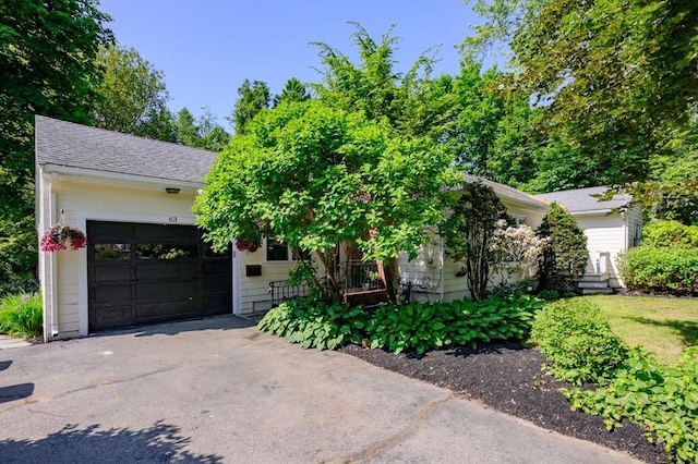63 Hawthorne, Weymouth, MA 02189 - obstructed view of property featuring a garage, asphalt driveway, and roof with shingles