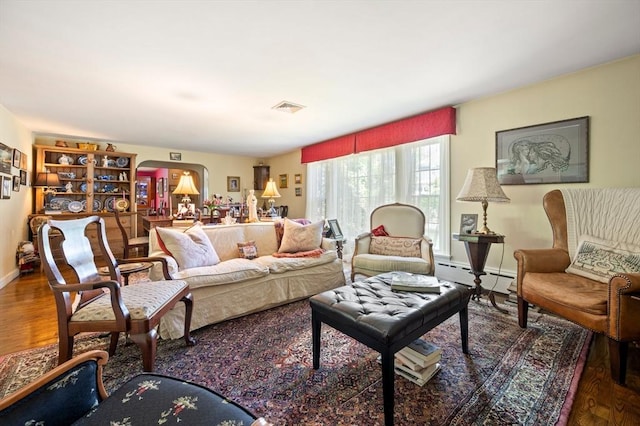 63 Hawthorne, Weymouth, MA 02189 - living area featuring wood finished floors, baseboard heating, baseboards, and arched walkways