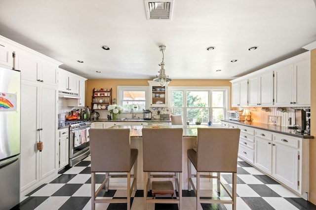 63 Hawthorne, Weymouth, MA 02189 - kitchen with dark floors, appliances with stainless steel finishes, under cabinet range hood, a center island, and recessed lighting