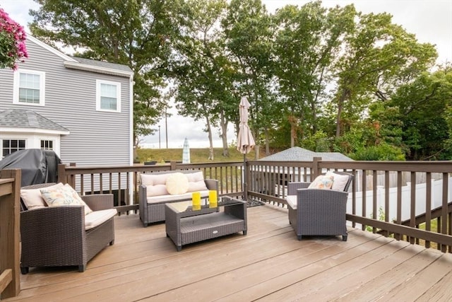 wooden terrace with area for grilling and an outdoor hangout area