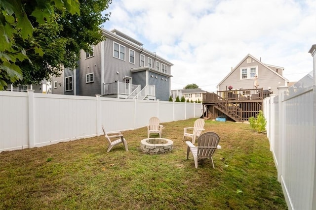 view of yard with an outdoor fire pit and a deck