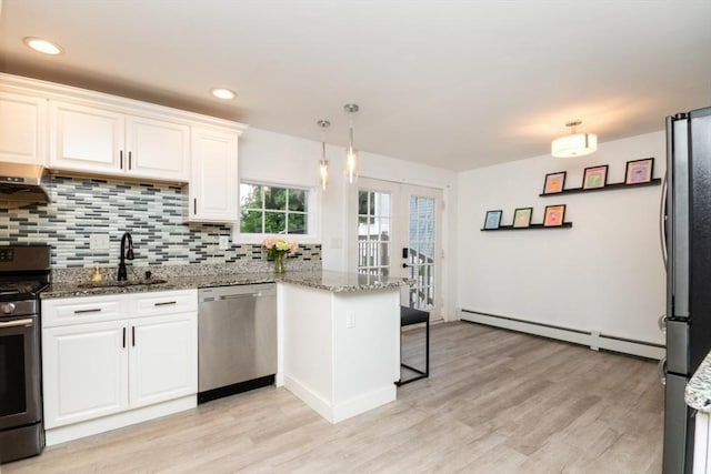 kitchen with stainless steel appliances, kitchen peninsula, sink, and white cabinets