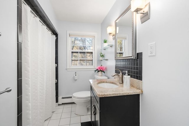 bathroom featuring a baseboard radiator, vanity, toilet, and tile patterned flooring