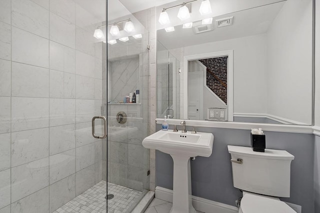 bathroom featuring a stall shower and toilet