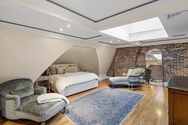 bedroom with crown molding, brick wall, baseboards, wood finished floors, and visible vents