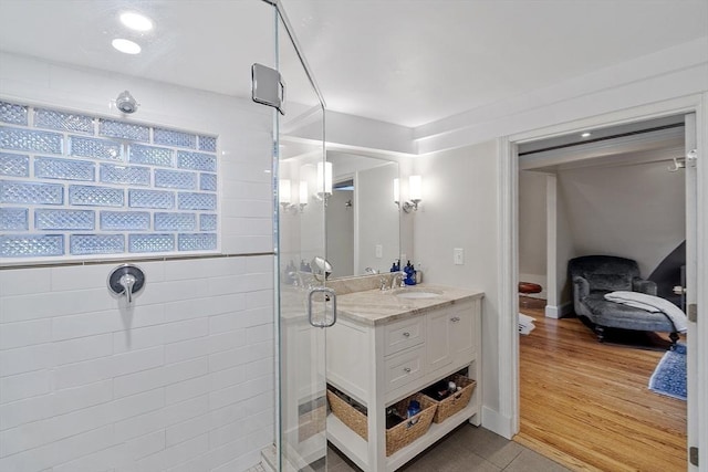 bathroom with a shower stall and vanity