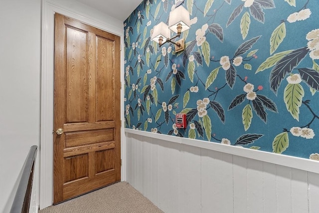interior space with a wainscoted wall and wallpapered walls
