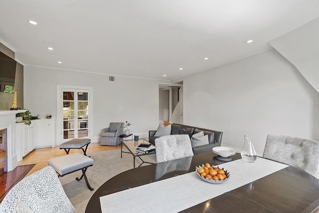dining area featuring crown molding, visible vents, stairs, light wood-type flooring, and recessed lighting