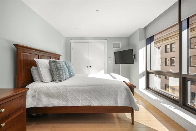 bedroom featuring light wood-type flooring and a closet