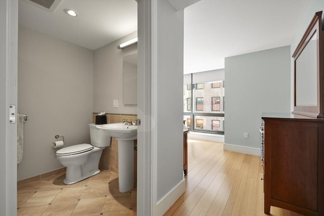 bathroom with toilet and wood-type flooring