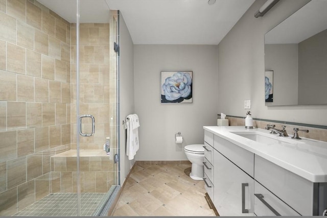 bathroom with an enclosed shower, vanity, and toilet