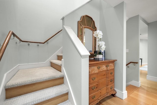 stairway featuring wood-type flooring