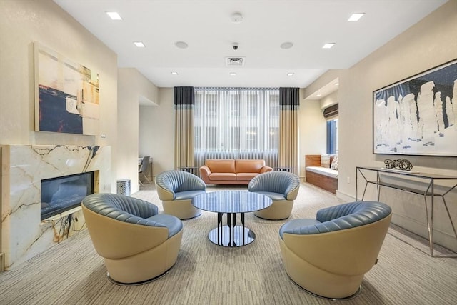 living room with light carpet and a fireplace