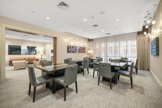 dining area featuring light colored carpet