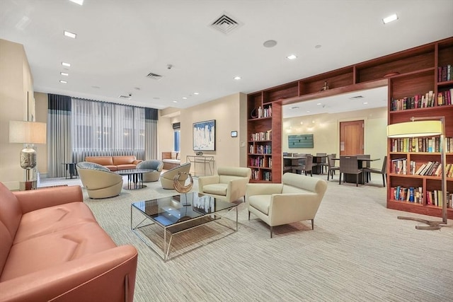 living room with light colored carpet and built in shelves