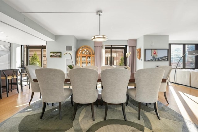 dining area featuring a wealth of natural light and light wood-type flooring