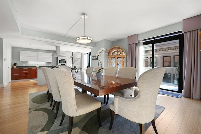 dining space with light wood-type flooring