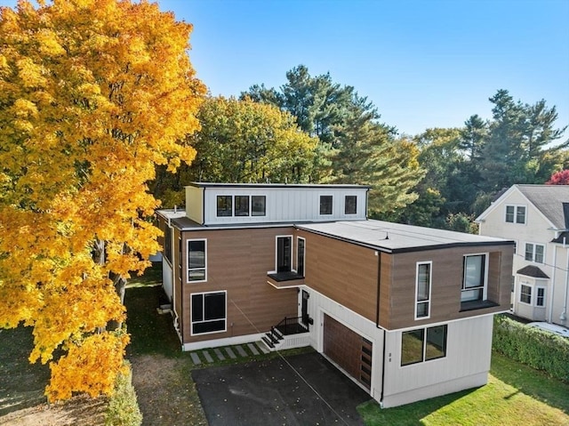 88 Lexington St, Newton, MA 02466 - rear view of house with a garage and asphalt driveway