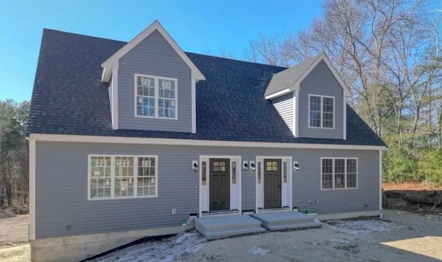cape cod house with a shingled roof