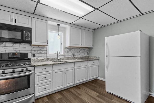 160 Stewart St, Fall River, MA 02720 - kitchen with freestanding refrigerator, stainless steel range with gas stovetop, black microwave, white cabinets, and a paneled ceiling