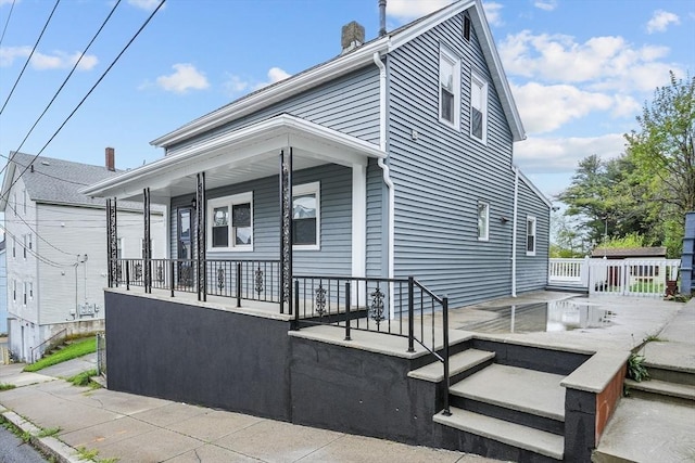160 Stewart St, Fall River, MA 02720 - view of property exterior featuring covered porch and a chimney