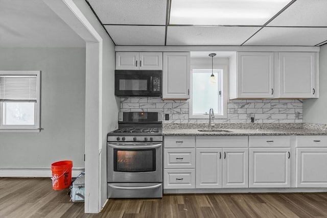 160 Stewart St, Fall River, MA 02720 - kitchen with stainless steel gas range, black microwave, white cabinetry, and a paneled ceiling