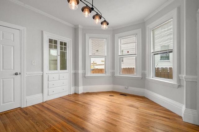 117 Babson St, Boston, MA 02126 - unfurnished dining area featuring light wood-style floors and crown molding