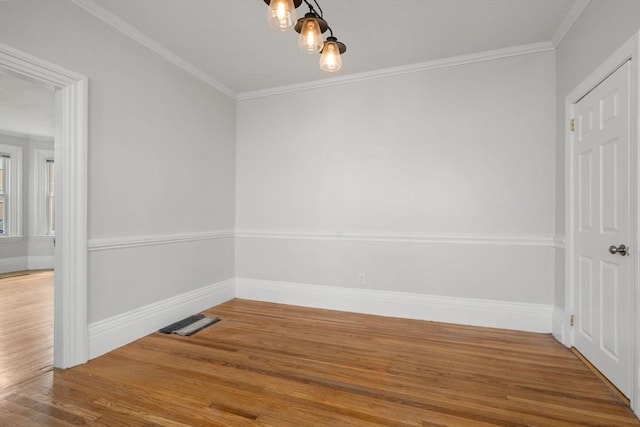 117 Babson St, Boston, MA 02126 - unfurnished dining area with wood finished floors, ornamental molding, and a chandelier
