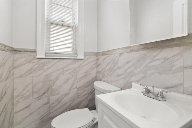 117 Babson St, Boston, MA 02126 - bathroom featuring tile walls, vanity, and a wainscoted wall