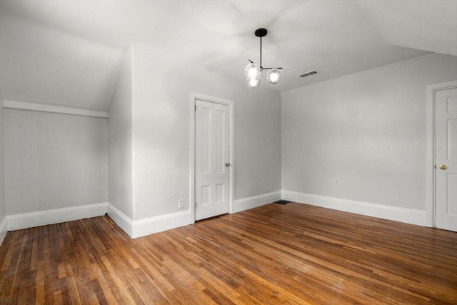117 Babson St, Boston, MA 02126 - bonus room with a chandelier, wood finished floors, and vaulted ceiling