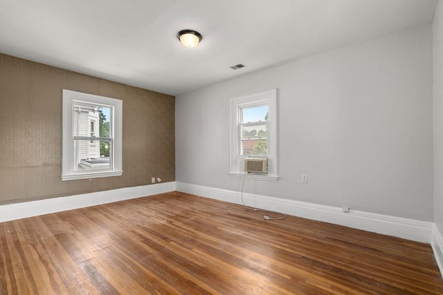 117 Babson St, Boston, MA 02126 - empty room featuring wood finished floors and cooling unit