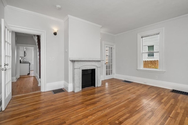 117 Babson St, Boston, MA 02126 - unfurnished living room with wood finished floors, a fireplace, and crown molding