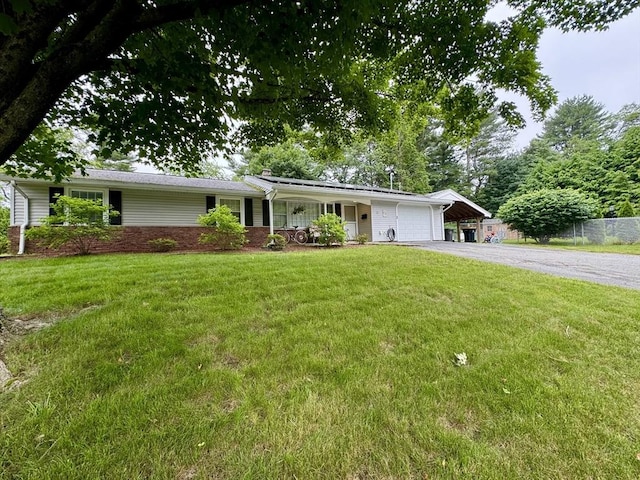 51 Karen Rd, Framingham, MA 01701 - ranch-style home with a garage, asphalt driveway, brick siding, and a chimney