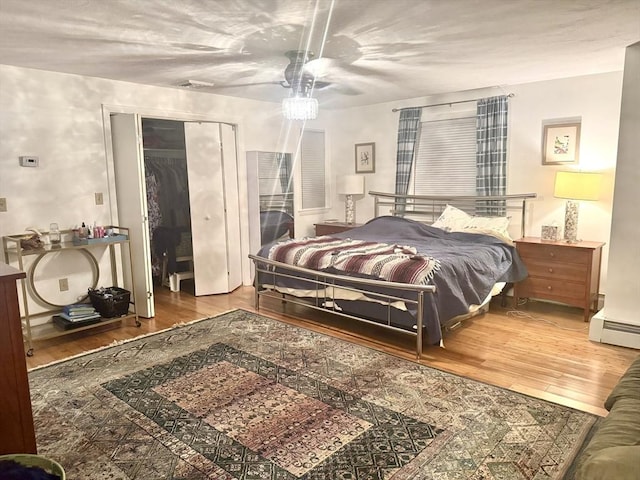 51 Karen Rd, Framingham, MA 01701 - bedroom featuring wood finished floors, a closet, baseboard heating, and ceiling fan