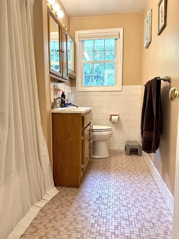 51 Karen Rd, Framingham, MA 01701 - full bath featuring vanity, a wainscoted wall, tile walls, and curtained shower