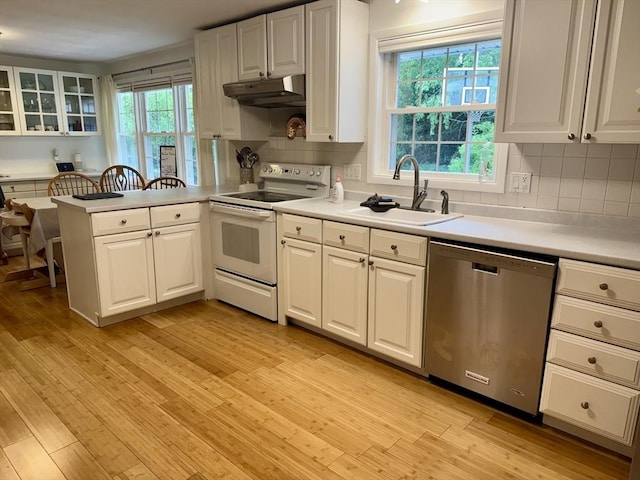 51 Karen Rd, Framingham, MA 01701 - kitchen with dishwasher, white range with electric cooktop, under cabinet range hood, white cabinetry, and a peninsula