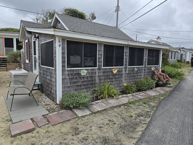 view of side of property featuring a sunroom