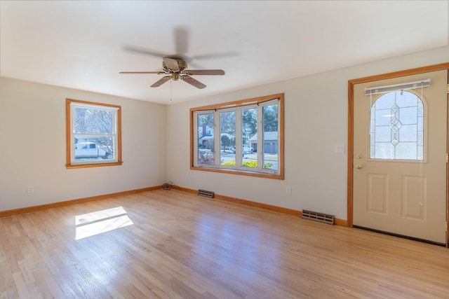 foyer entrance with visible vents, baseboards, and light wood-style floors