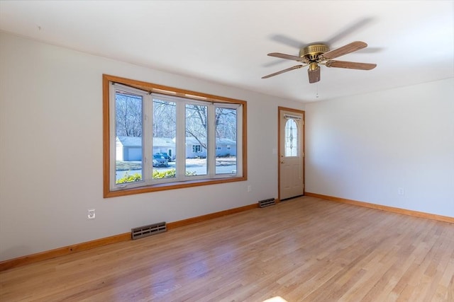 unfurnished room featuring visible vents, baseboards, ceiling fan, and light wood finished floors