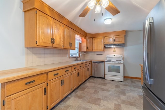 kitchen featuring under cabinet range hood, a sink, tasteful backsplash, appliances with stainless steel finishes, and light countertops