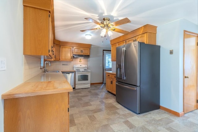 kitchen featuring ceiling fan, a sink, under cabinet range hood, appliances with stainless steel finishes, and tasteful backsplash