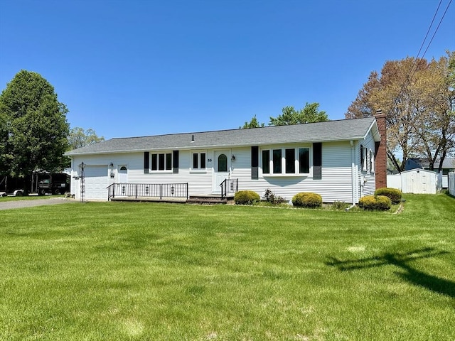 89 Napoleon Ave, Ludlow, MA 01056 - ranch-style home featuring a chimney, an attached garage, a front yard, and driveway