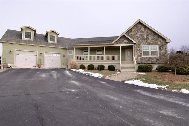 view of front of property with a porch and a garage