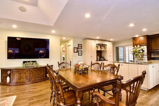 dining space featuring sink and light wood-type flooring