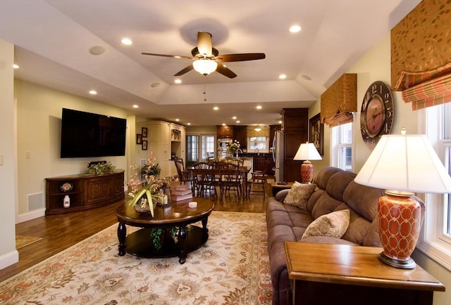 living room with vaulted ceiling, ceiling fan, and hardwood / wood-style flooring