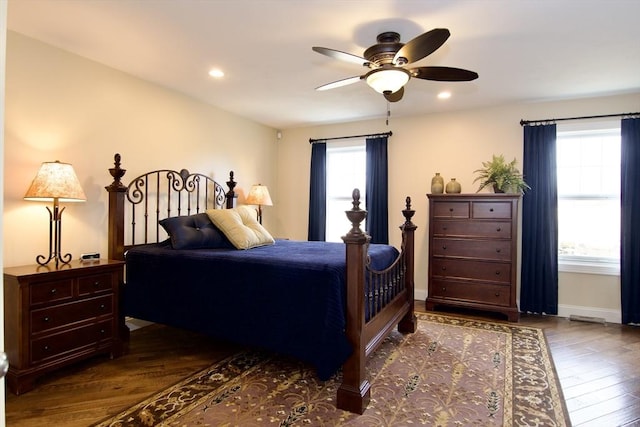 bedroom with ceiling fan and dark hardwood / wood-style flooring