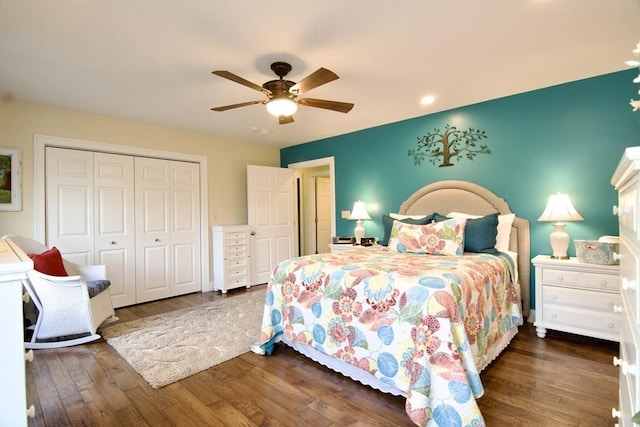 bedroom with ceiling fan, a closet, and dark hardwood / wood-style floors