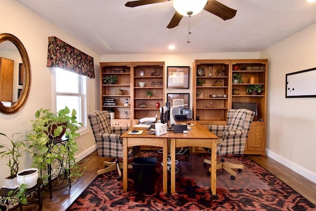 office space featuring ceiling fan and dark hardwood / wood-style flooring