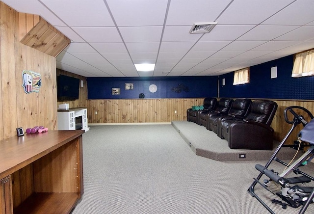 carpeted home theater with wooden walls